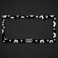 Black license plate frame with white floral print and a drip-style logo along the bottom