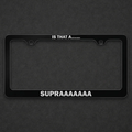 Black Supra license plate frame with white lettering on a charcoal textured background