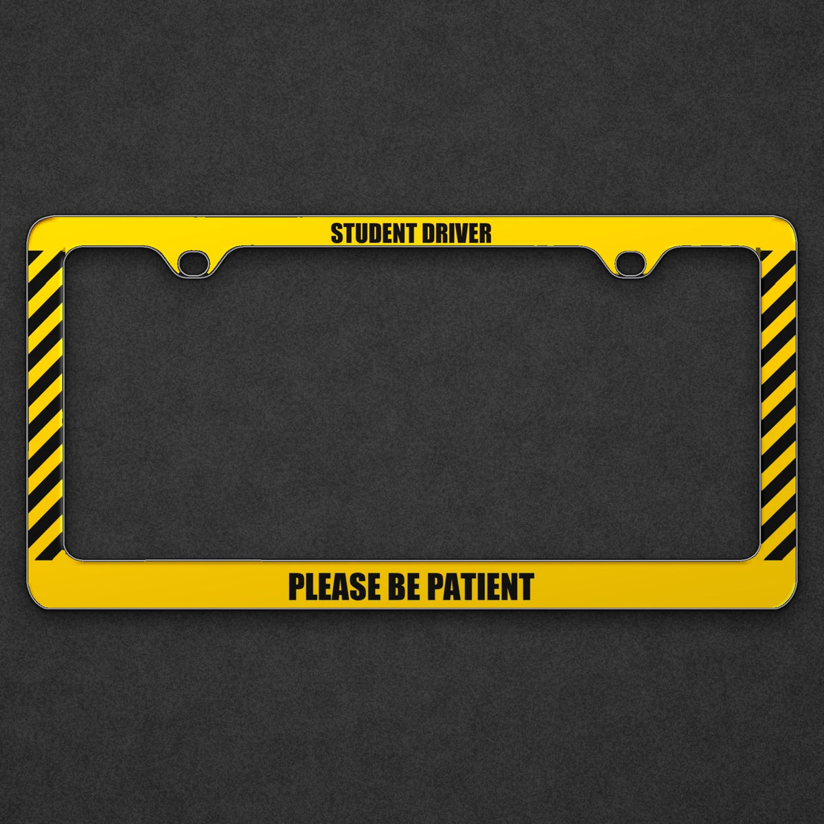 Yellow Student Driver Please Be Patient license plate frame on a charcoal background